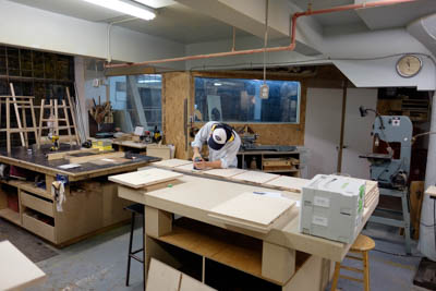 Adrien is sanding the panels of the future TV stand.