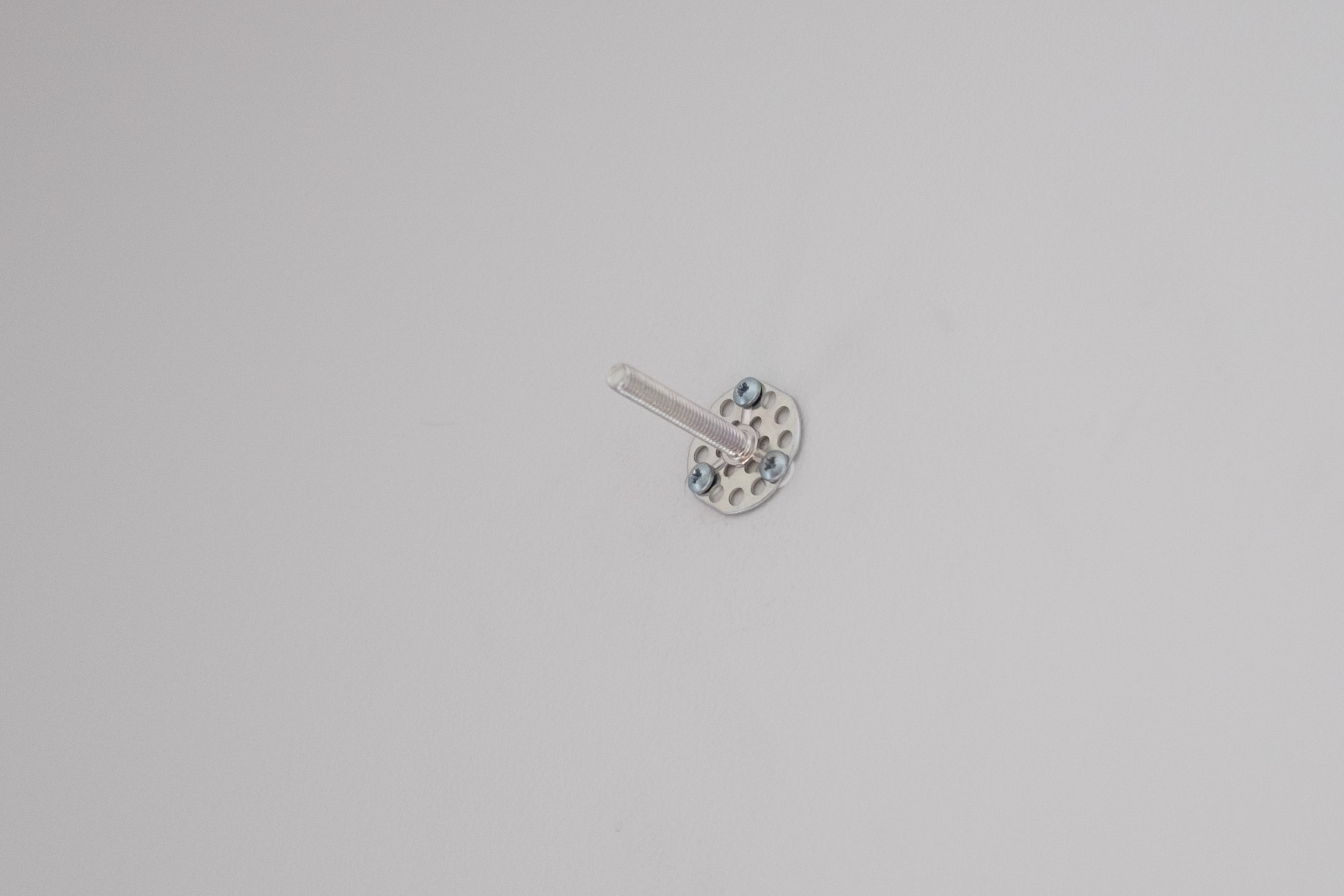 Harware with the rod mounted on the wall.