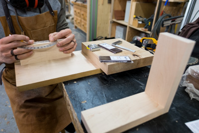 Me mesuring the angle of the grooves for the tablets to sit in.