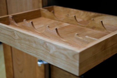 A closeup of the wooden rack inside the drawer.