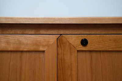 A closeup of the top of the cabinet door where the keylock is.